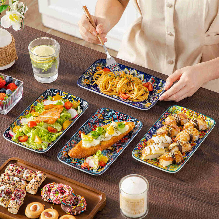 Simi 8.5-inch floral porcelain serving platters with snacks, lemonade and a white vase on a dark wooden table.