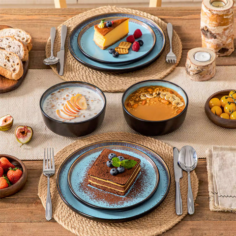 Rustic dining table with Amber 12-piece stoneware dinnerware in farmhouse blue - featuring reactive glaze plates - bowls - and utensils by vancasso