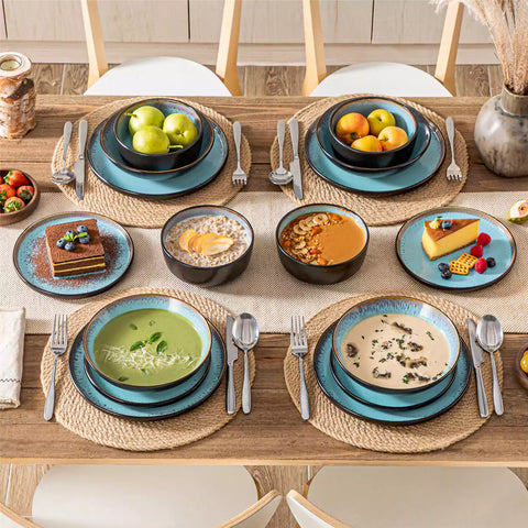 Assorted dishes with soup - dessert - and fruit salad on rustic wooden table - Amber 16-Piece blue stoneware dinnerware set with plates and bowls by vancasso
