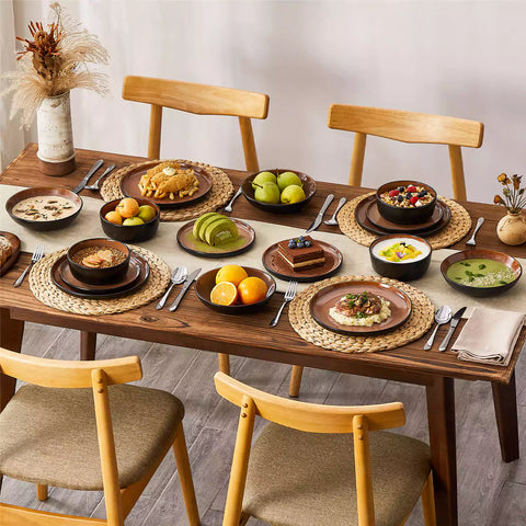Assorted dishes with soup - dessert - and fruit salad on rustic wooden table - Amber 16-Piece red stoneware dinnerware set with plates and bowls by vancasso