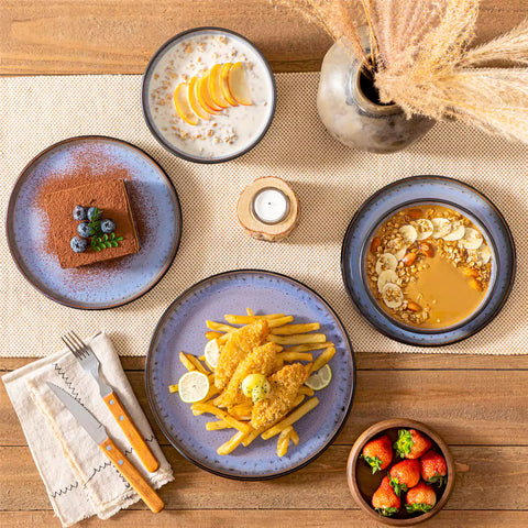 Rustic dining table with Amber 12-piece stoneware dinnerware in farmhouse violet - featuring reactive glaze plates - bowls - and utensils by vancasso