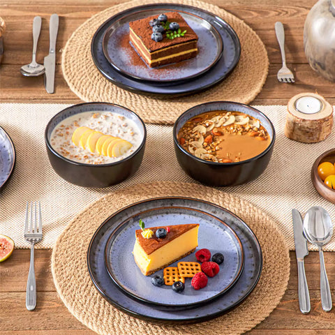 Rustic dining table with Amber 12-piece stoneware dinnerware in farmhouse violet - featuring reactive glaze plates - bowls - and utensils by vancasso