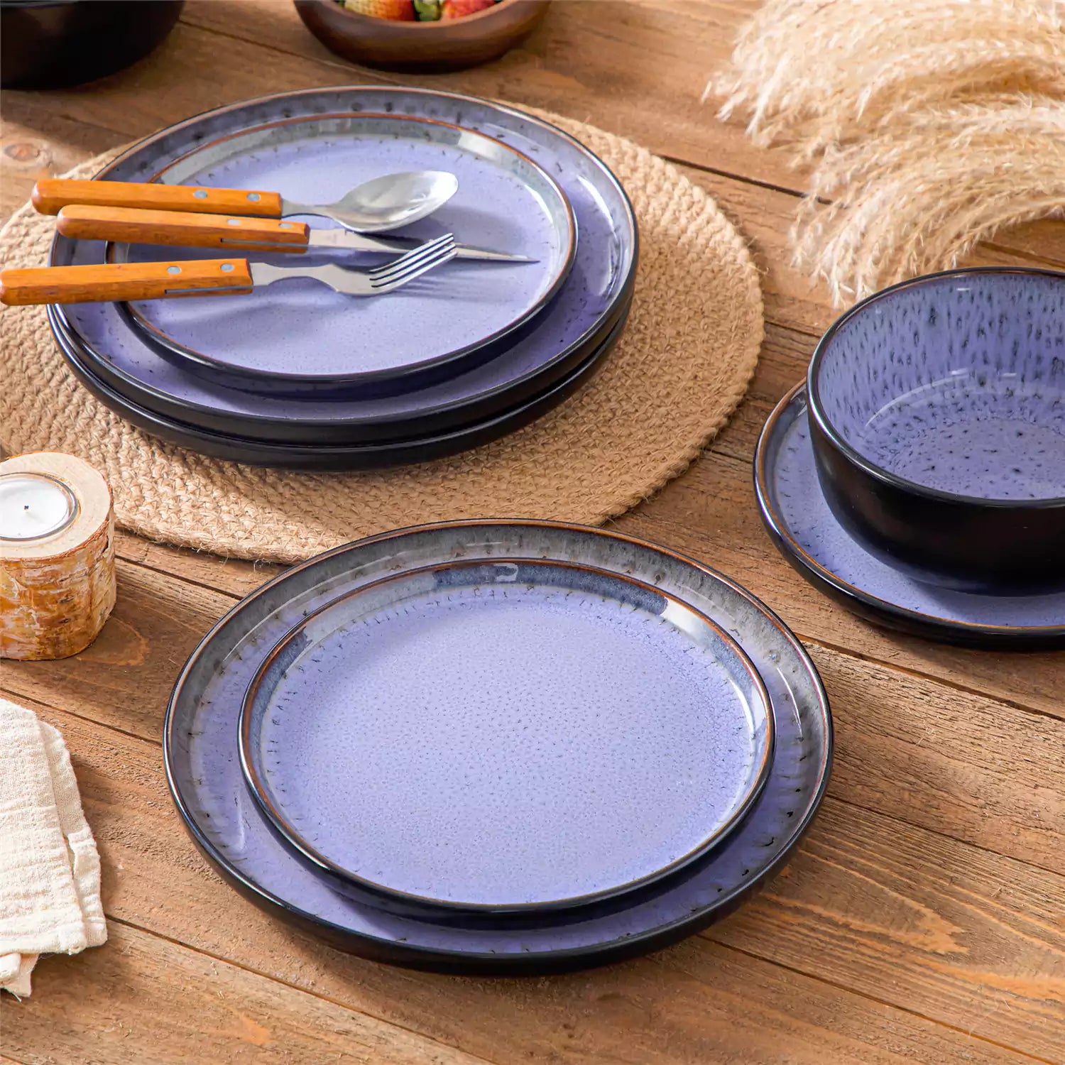 Rustic dining table with Amber 12-piece stoneware dinnerware in farmhouse violet - featuring reactive glaze plates - bowls - and utensils by vancasso