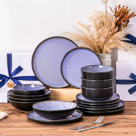 Assorted dishes with soup - dessert - and fruit salad on rustic wooden table - Amber 16-Piece violet stoneware dinnerware set with plates and bowls by vancasso