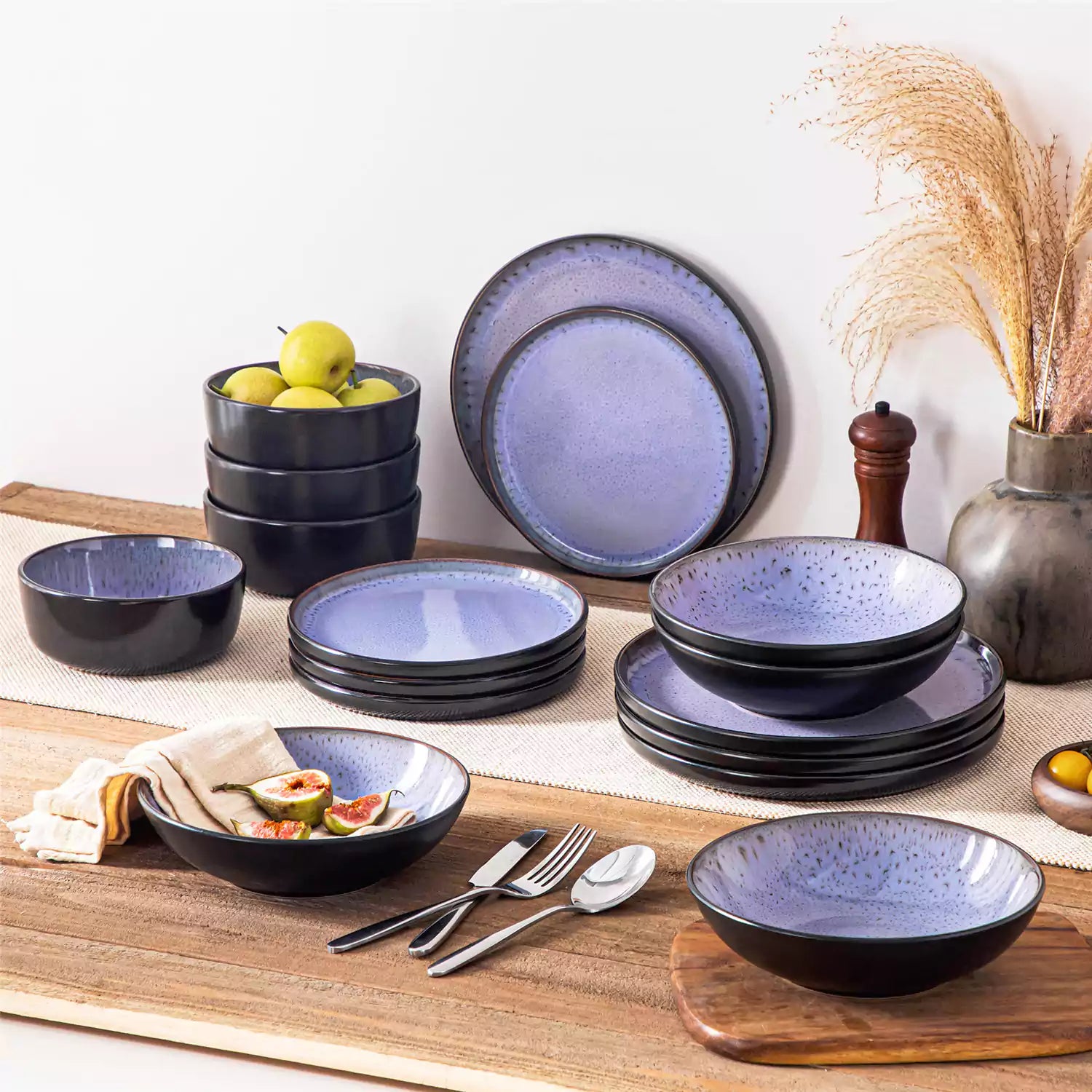 Assorted dishes with soup - dessert - and fruit salad on rustic wooden table - Amber 16-Piece violet stoneware dinnerware set with plates and bowls by vancasso