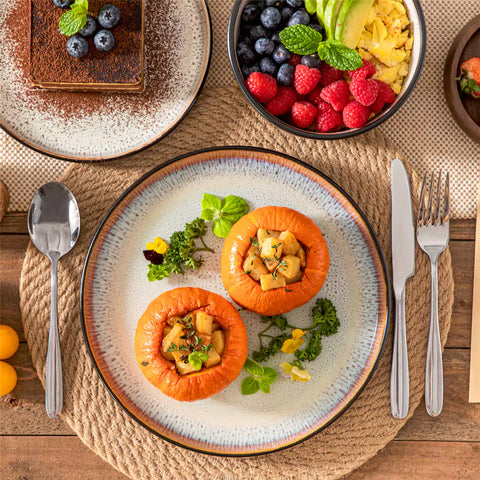 Rustic dining table with Amber 12-piece stoneware dinnerware in farmhouse beige - featuring reactive glaze plates - bowls - and utensils by vancasso