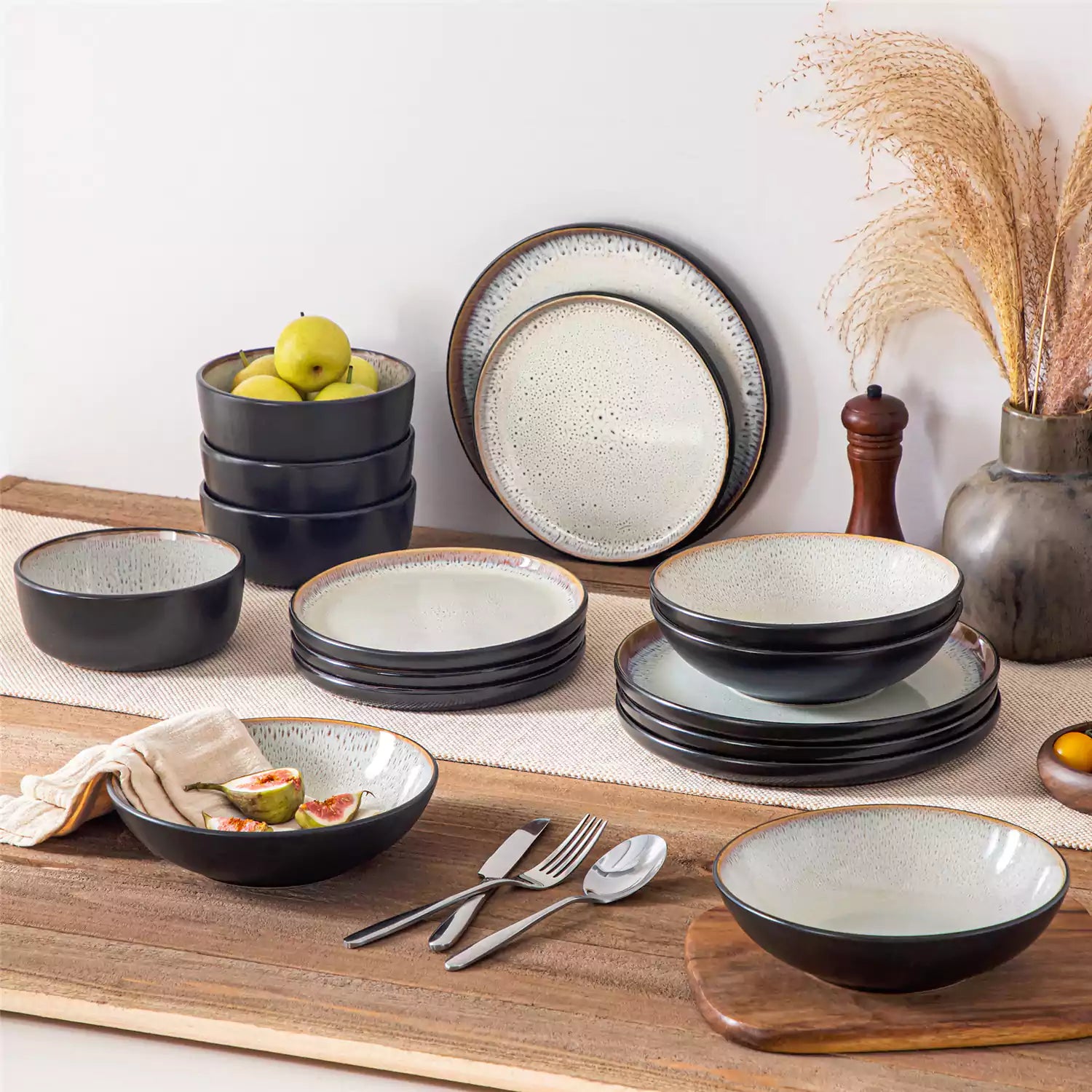 Assorted dishes with soup - dessert - and fruit salad on rustic wooden table - Amber 16-Piece beige stoneware dinnerware set with plates and bowls by vancasso