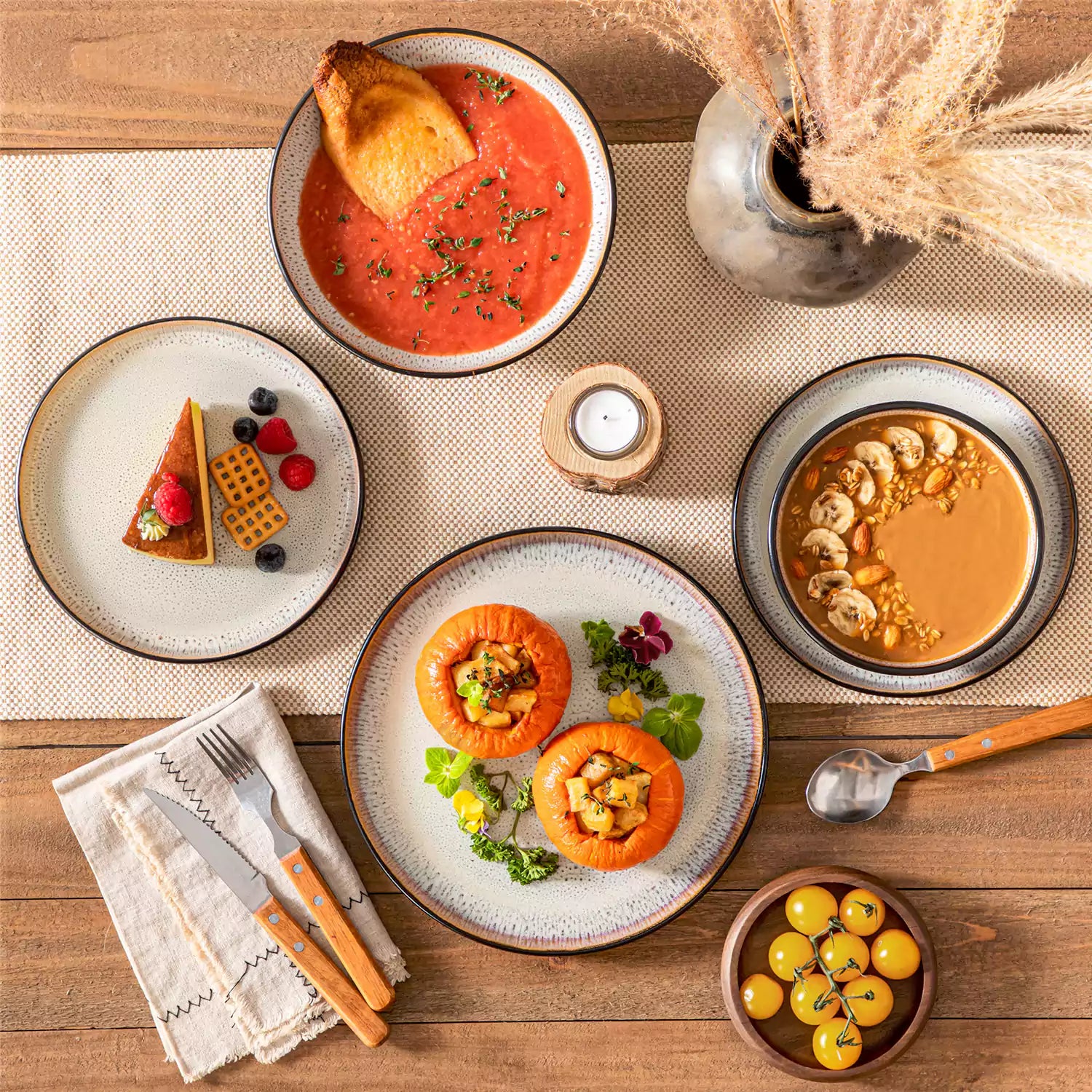 Assorted dishes with soup - dessert - and fruit salad on rustic wooden table - Amber 16-Piece beige stoneware dinnerware set with plates and bowls by vancasso