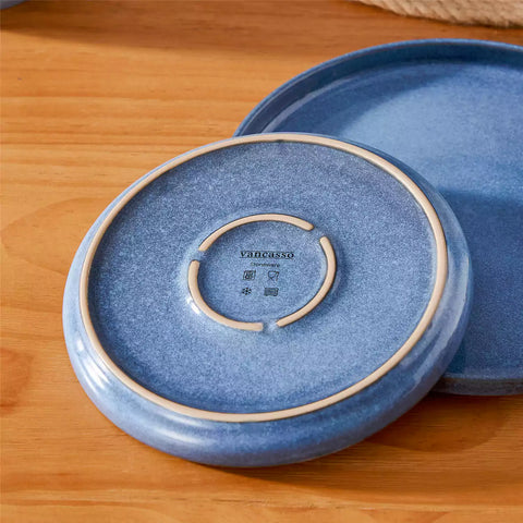 Handcrafted blue stoneware with reactive glaze on woven placemats - perfect for farmhouse tables