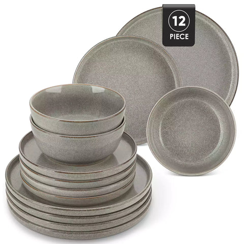 Brown stoneware plates and bowls with reactive glaze on farmhouse wooden table with woven placemats