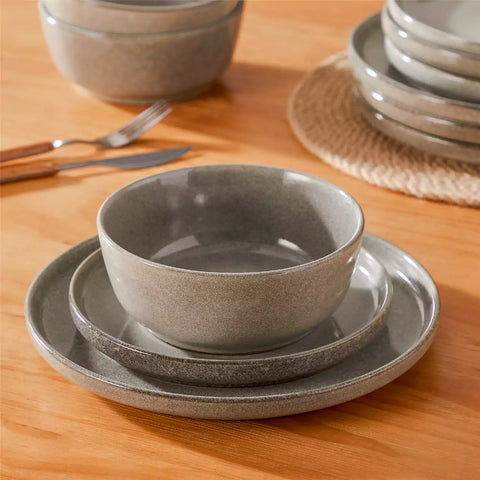 Handcrafted brown stoneware with reactive glaze on woven placemats - perfect for farmhouse tables