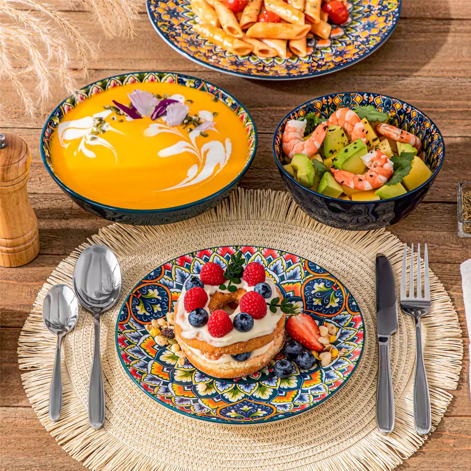 Lumi 24 piece porcelain dinnerware set with vibrant patterns stacked on a wooden table with colorful placemats and assorted dishes