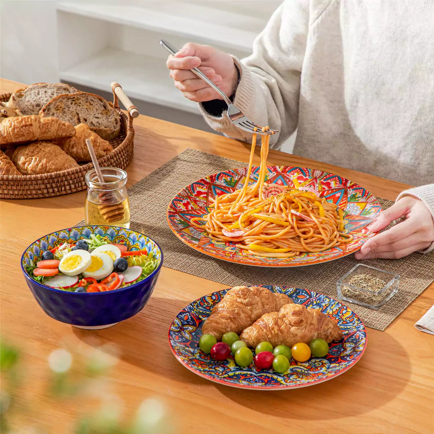 Bohemian Lumi 12 piece porcelain dinnerware set with vibrant patterned plates diamond embossed bowls served with steak eggs and fresh fruit on a wooden table