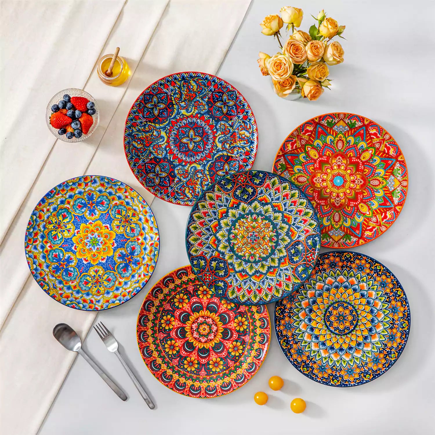 Lumi 6-piece 10.5'' Bohemian dinner plates with colorful mandala patterns on a white table with fruit and cutlery