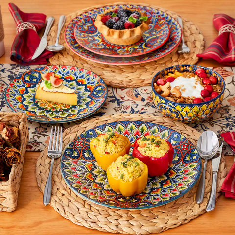 Lumi 18-piece Bohemian dinnerware set for six on a wooden table with colorful plates bowls and silverware in a playful Boho style