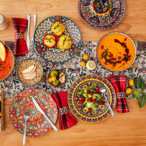 Bohemian style dining table set with Lumi 24 piece colorful dinnerware bowls and vibrant table décor ready for a lively meal