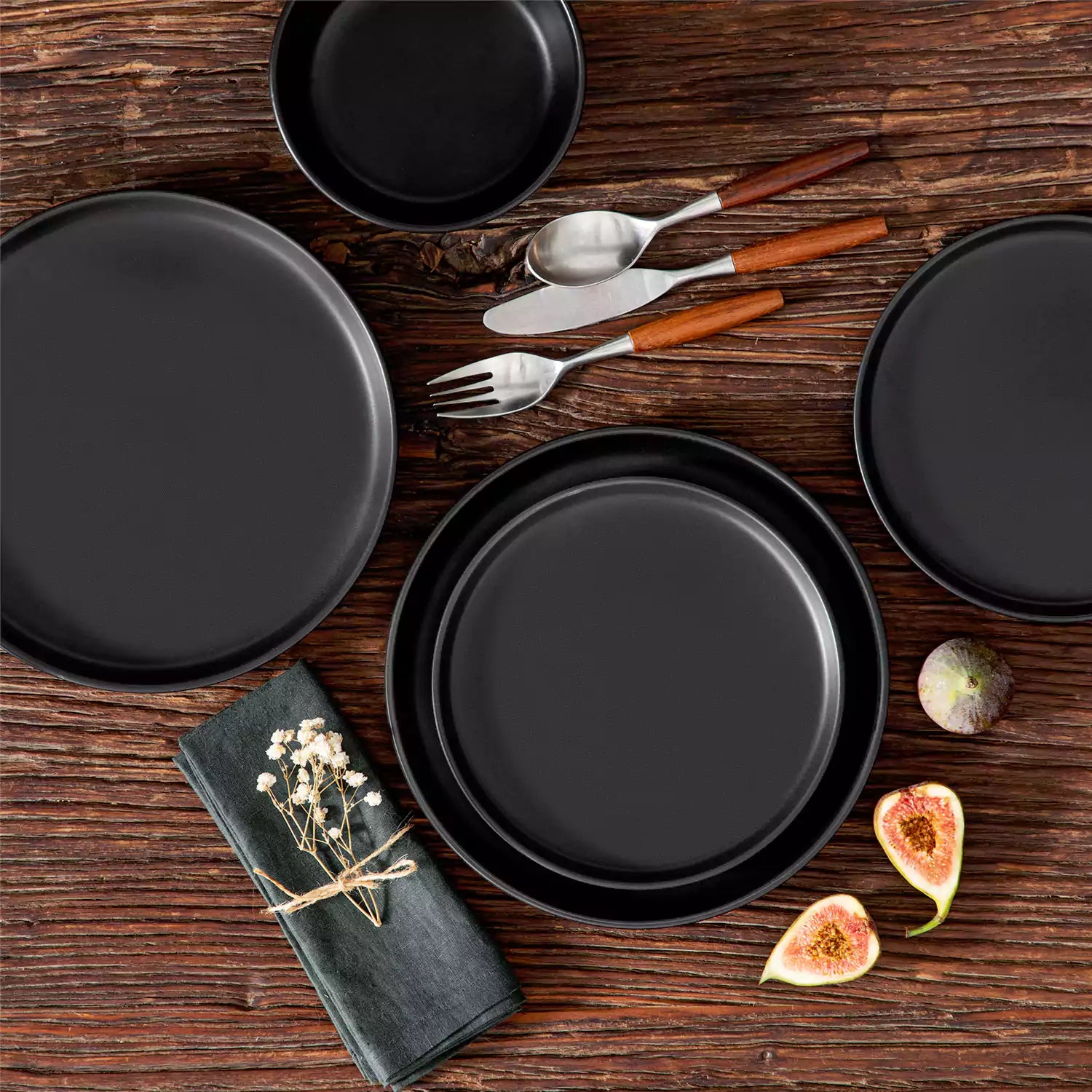 A matte black 16-piece stoneware dinnerware set from the Playa collection - offering a modern touch with plates and bowls for 4 people-vancasso.