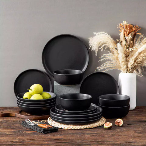 A matte black 16-piece stoneware dinnerware set from the Playa collection - offering a modern touch with plates and bowls for 4 people-vancasso.