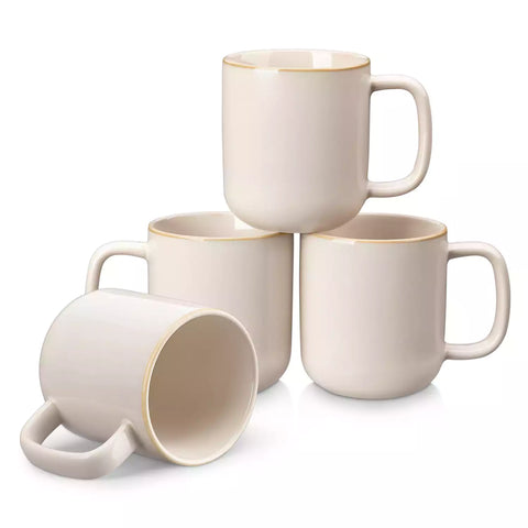 Playa 12oz stoneware mugs in glossy beige reactive glaze on a rustic wooden table for a cozy breakfast with fresh coffee pastries and berries