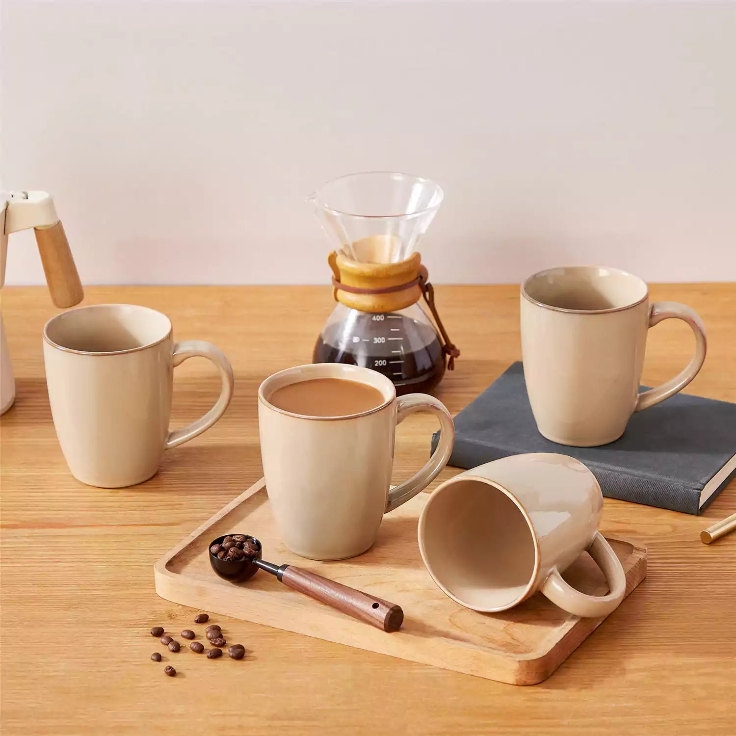 Playa 16oz stoneware mugs in brown reactive glaze on a rustic wooden surface for a cozy morning pour with coffee carafe and scattered beans