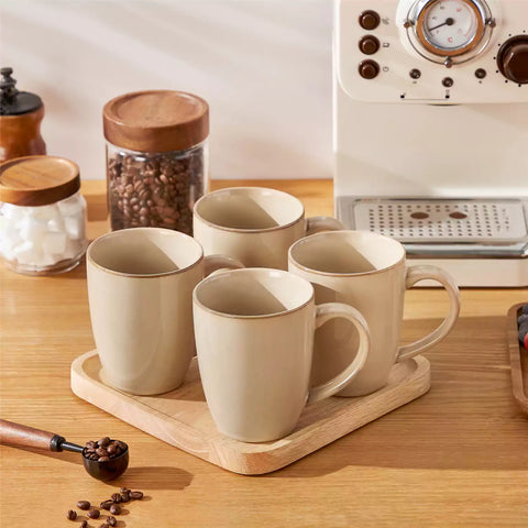 Playa 16oz stoneware mugs in brown reactive glaze on a rustic wooden surface for a cozy morning pour with coffee carafe and scattered beans