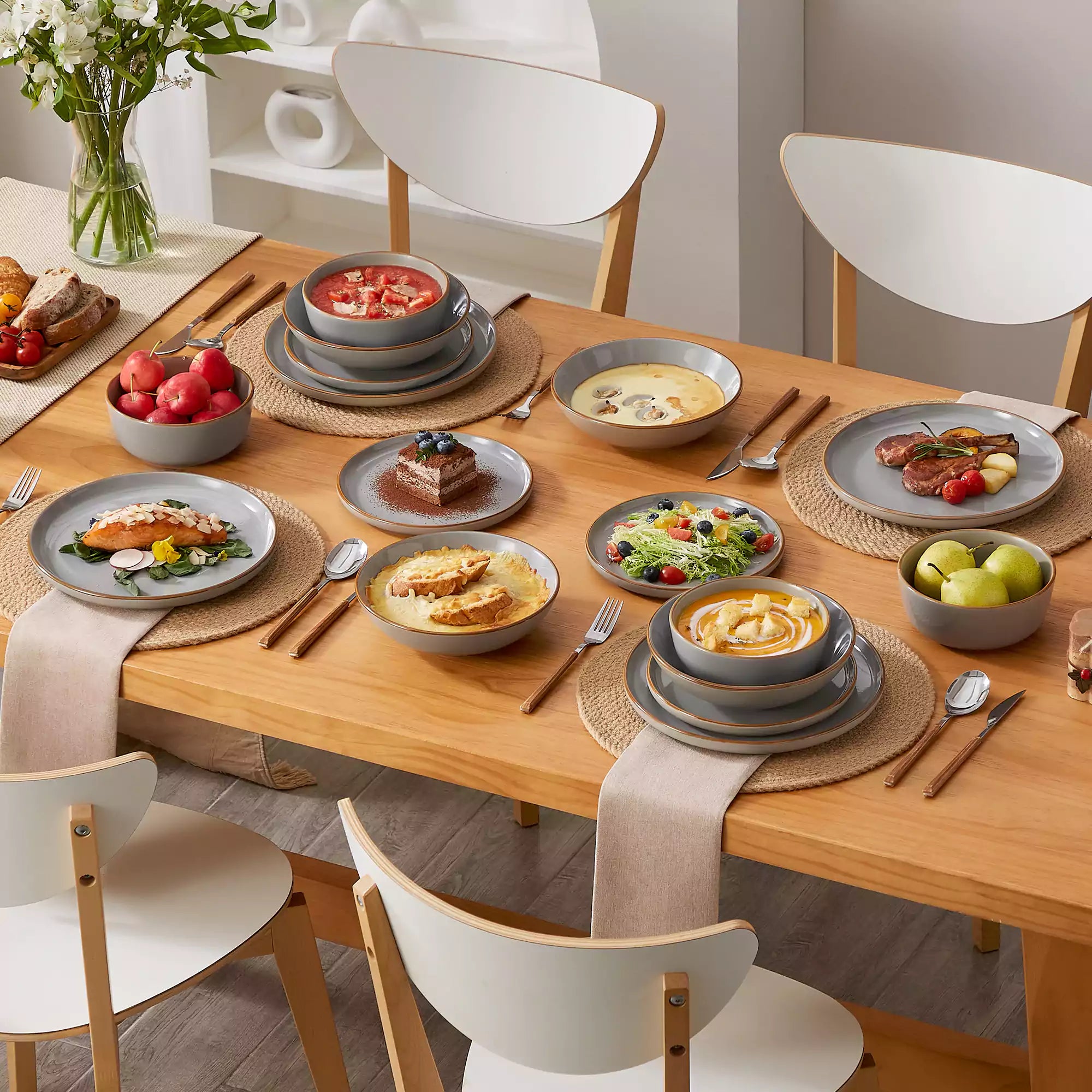Rustic grey speckled stoneware dinnerware set with lipped-edge plates and bowls arranged on a sunlit modern dining table-vancasso