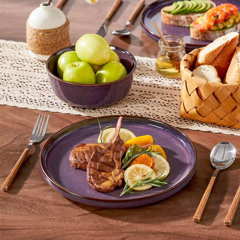 Sata purple stoneware dinner plate set of 4 styled with lamb chops and vegetables on a dinner table farmhouse lipped edge reactive glaze one of a kind finish