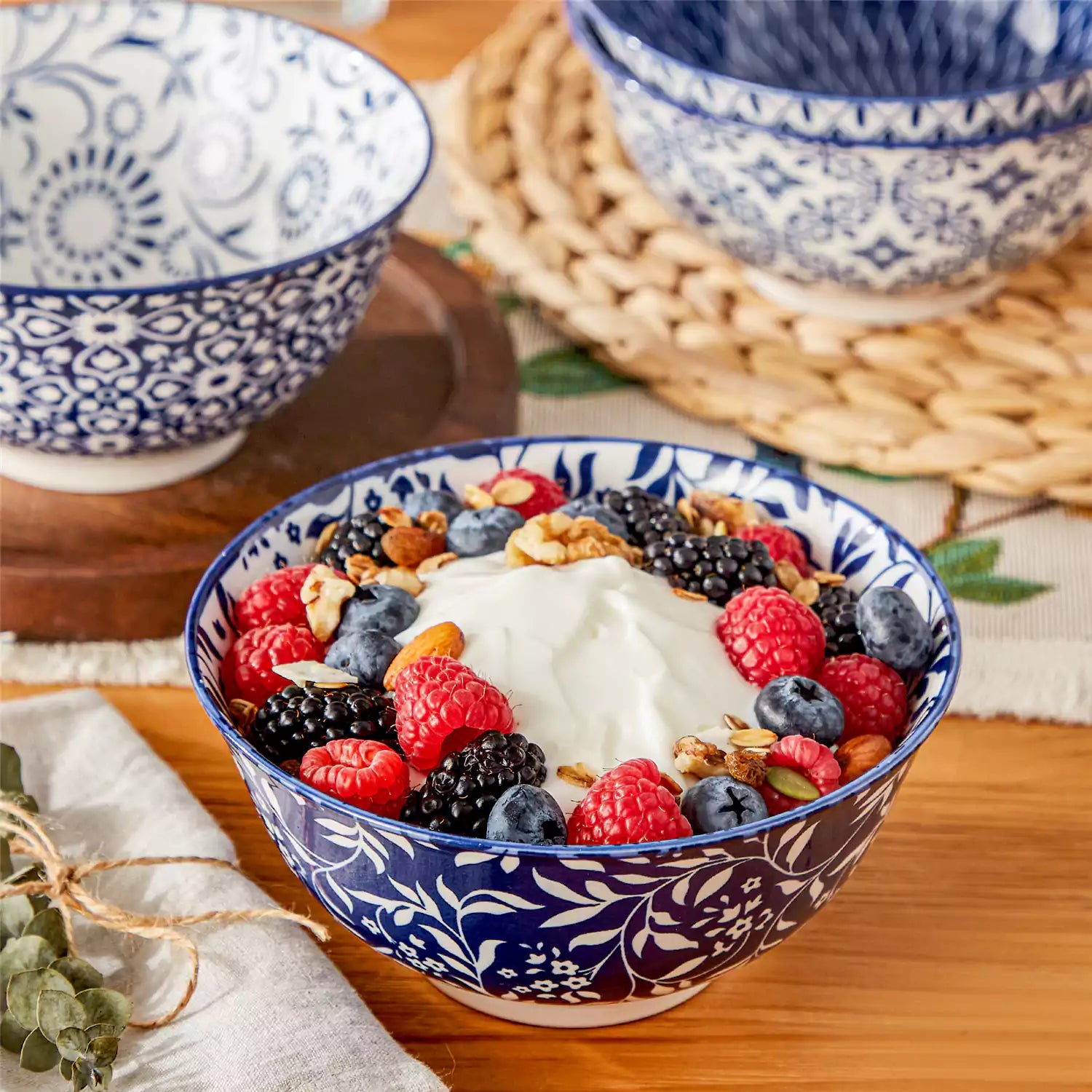 Selene porcelain cereal bowls set of 4 blue and white Japanese inspired floral pattern mix and match tableware styled with fruits and dishes on dining table