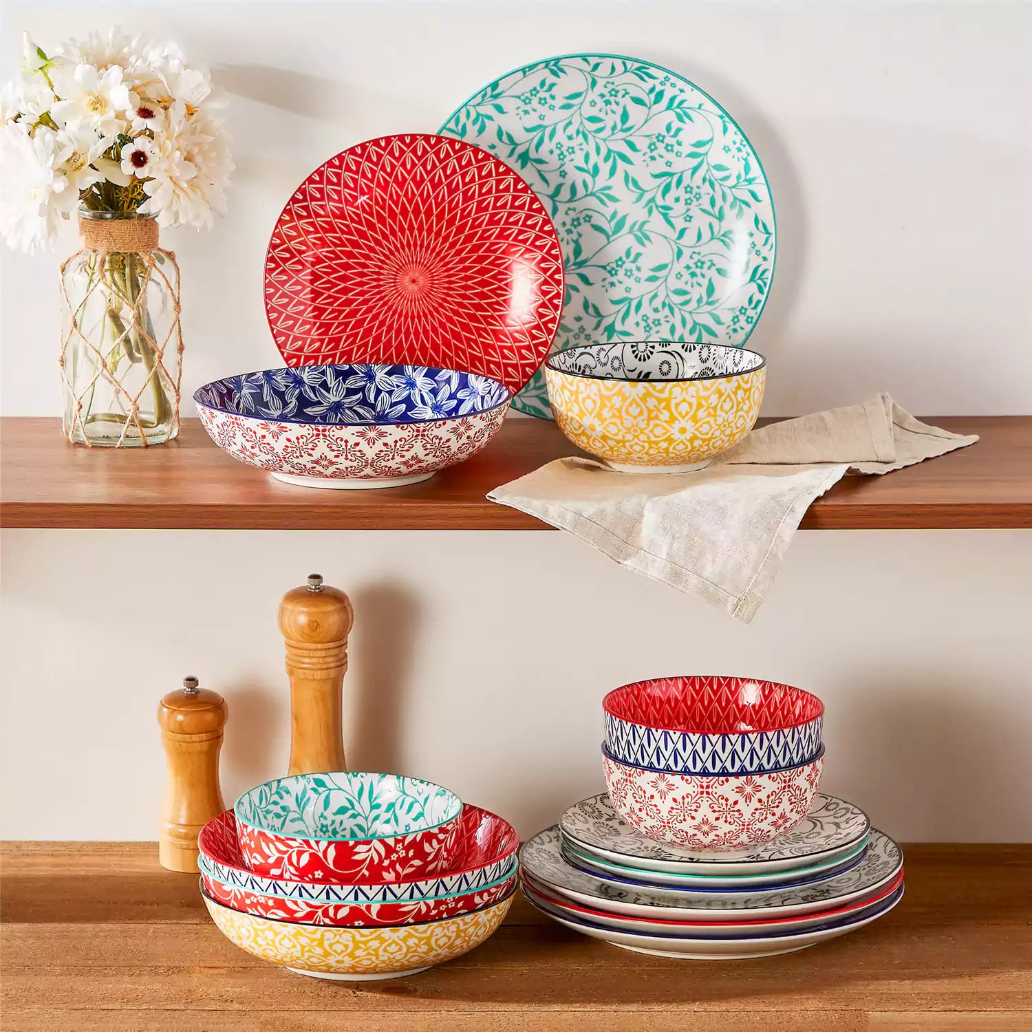 16 piece Japanese porcelain dinnerware set with indigo and earth tone floral geometric patterns on white ceramic plates and bowls