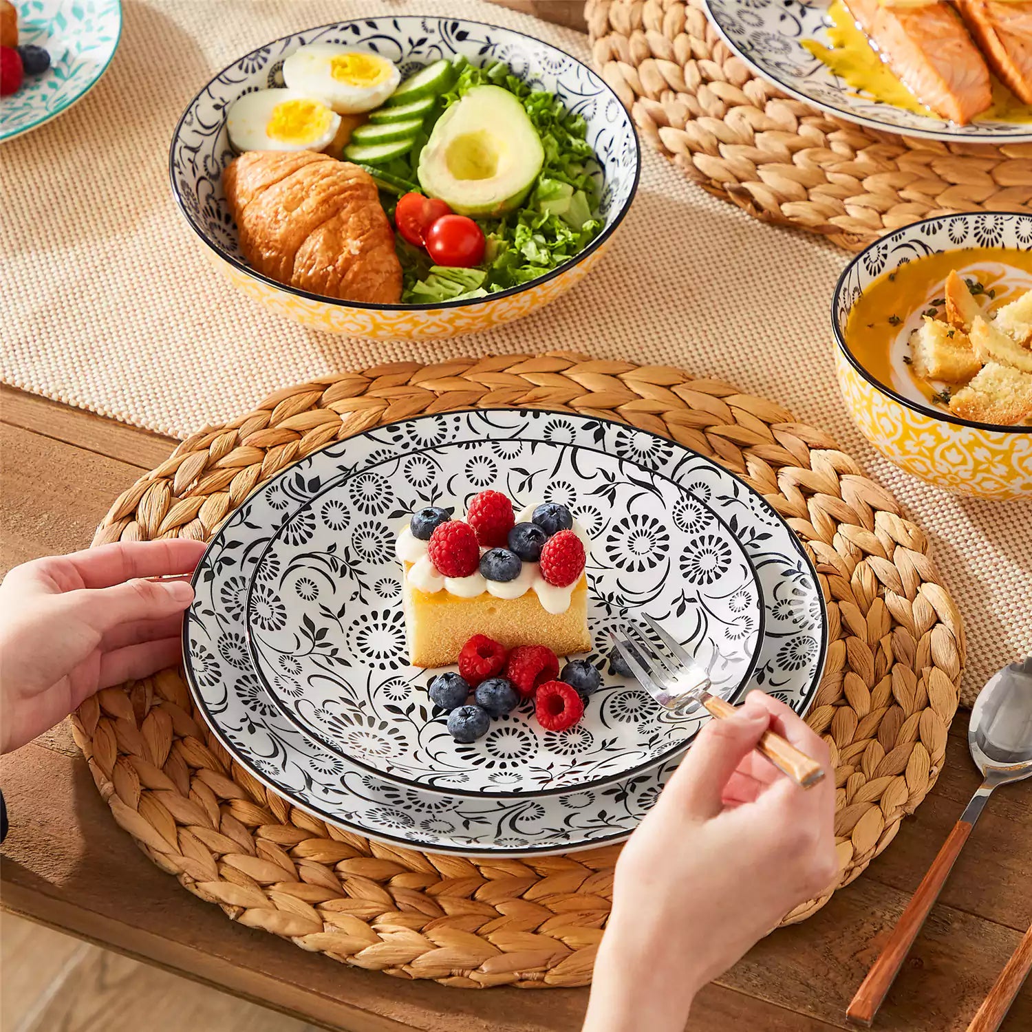 16 piece Japanese porcelain dinnerware set with indigo and earth tone floral geometric patterns on white ceramic plates and bowls