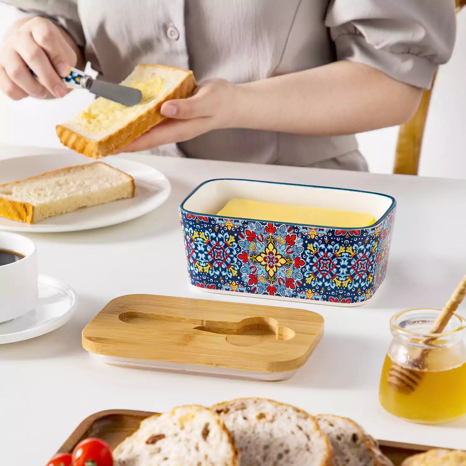 Midnight blue porcelain butter dish with wooden lid in boho chic style - perfect for a colorful breakfast table with bread and coffee-vancasso