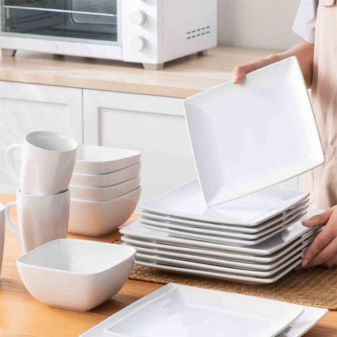 A glossy white 24-piece stoneware dinnerware set from the Soho collection - featuring a sleek square design with plates and mugs for 6 people-vancasso