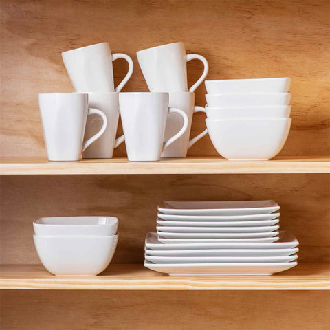 A glossy white 24-piece stoneware dinnerware set from the Soho collection - featuring a sleek square design with plates and mugs for 6 people-vancasso