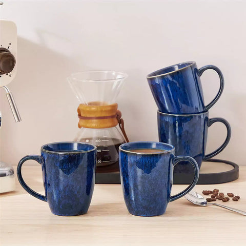 Blue Starry 12oz stoneware mugs set of 4 with reactive glaze finish on a kitchen counter with coffee milk and fresh bread