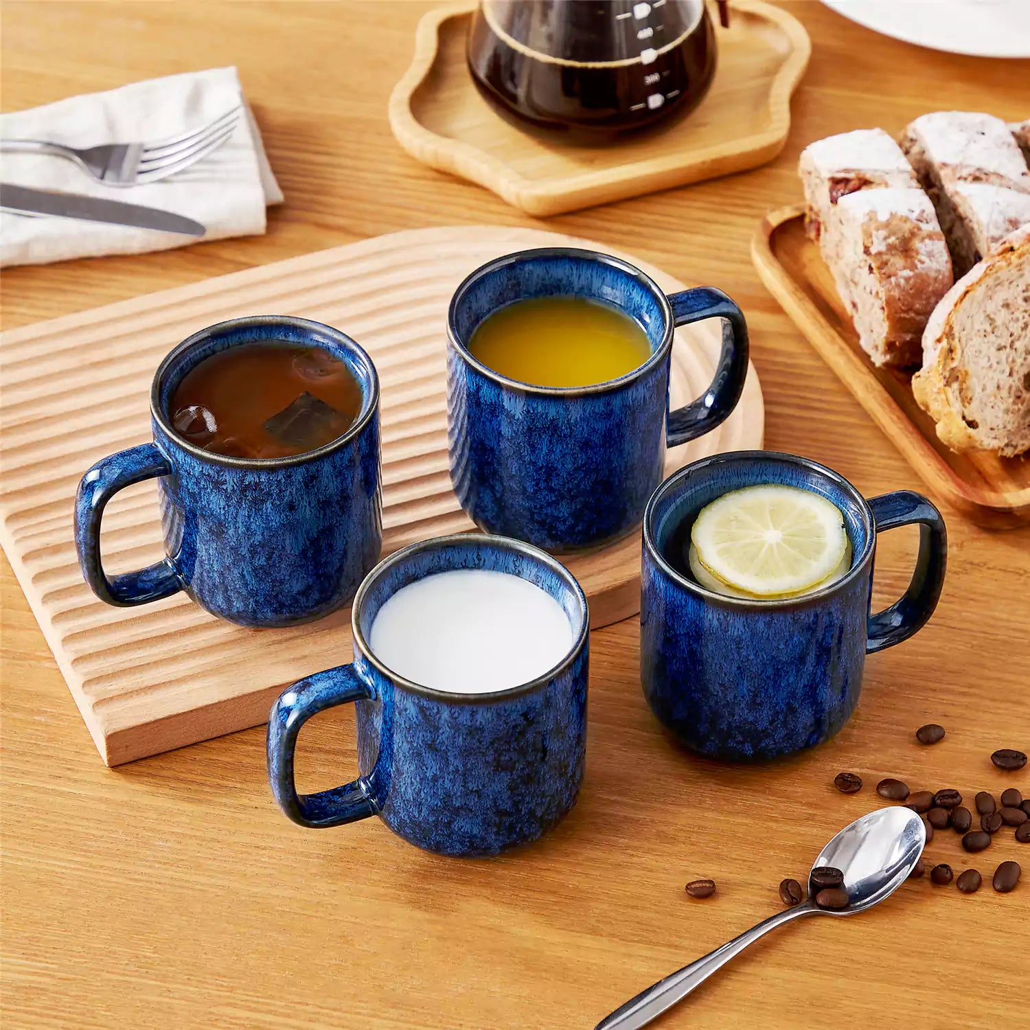 Starry blue 12oz stoneware mugs set of 4 with coffee on wooden table next to coffee maker and fresh bread cozy breakfast scene